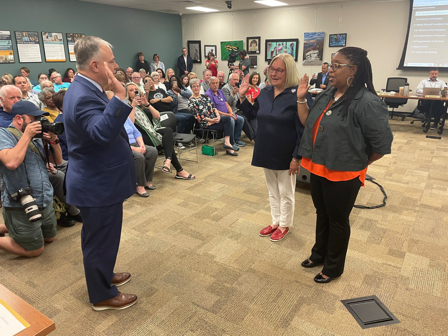 Judy Brunner and Shurita Thomas-Tate are sworn in April 11 by Greene County Clerk Shane Schoeller.